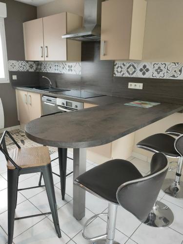 a kitchen with a table and chairs in it at Tresor de Beaurains in Beaurains