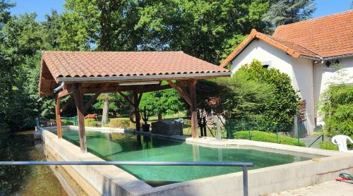 - une piscine avec un kiosque à côté d'une maison dans l'établissement Détendez-vous à Montverdun, à Montverdun