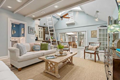 a living room with a couch and a table at Guilford Carriage House at Granite Lodge! in Guilford
