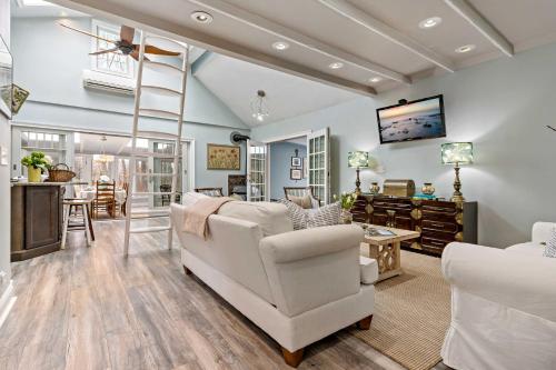 a living room with white furniture and a ladder at Guilford Carriage House at Granite Lodge! in Guilford