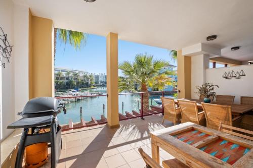 a dining room with a view of the water at Palm Serenity - Sotogrande in Sotogrande