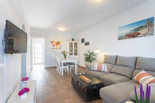 a living room with a couch and a table at La Casita del Albir in Albir