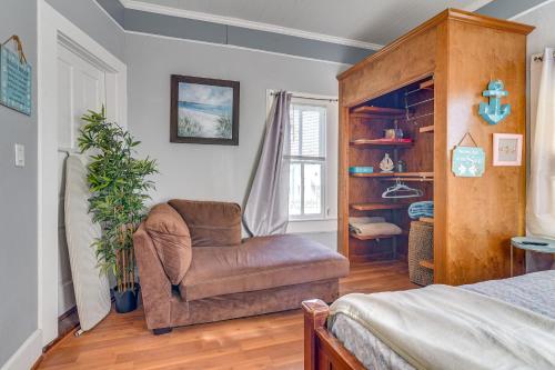 a bedroom with a chair and a bed at Coastal Galveston Studio about 1 Mi to Beach! in Galveston