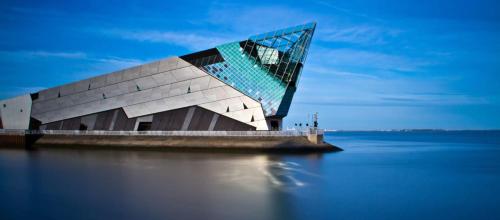 a building on the water with a body of water at City Centre 1 Bed Sleeps 4 H5 in Hull