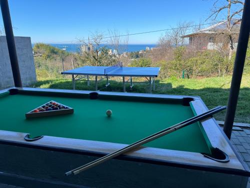 a pool table with a cue and a ball at Annas Glamping in Batumi
