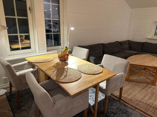 a living room with a wooden table and chairs at Bagargården 8 in Åre