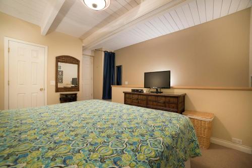 a bedroom with a bed and a flat screen tv at Maui Vista 3406 - Ocean View Penthouse Sleeps 7 in Kihei