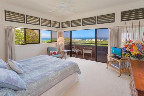 een slaapkamer met een bed en uitzicht op de oceaan bij 2711 Ridge in Kahana