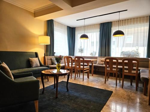a living room with a table and chairs at Appartements Monuth in Bad Hofgastein