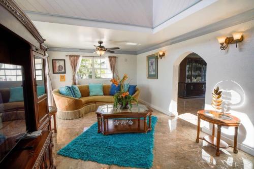 a living room with a couch and a table at NEW Chalk Sound Home BBQ Pool Beach Steps Away in Providenciales
