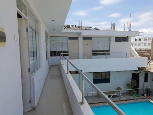 a balcony of a building with a swimming pool at HOTEL PARAACO in Paracas