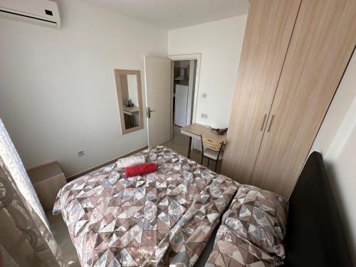 a bedroom with a bed with a red pillow on it at Kyrenia center, 2 bedroom, 1 living room, residential apartment in Kérynia