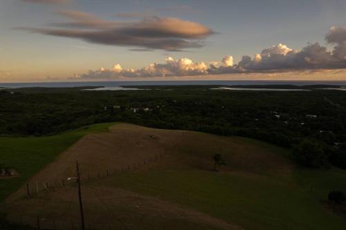 an aerial view of a field with a fence at Hill Top Apartment with 360 Degree Balcony View in Vieques