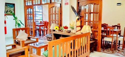 a living room with wooden furniture and a fireplace at Paraiso Wasi in Tarapoto