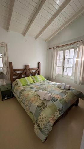 a bedroom with a bed with a quilt on it at La Isla Ostende in Ostende
