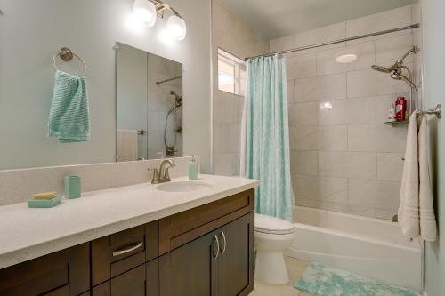 a bathroom with a sink and a toilet and a shower at Ewa Beach Apartment about 1 Mi to Puʻuloa Beach Park! in Kapolei