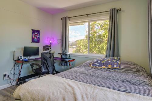 a bedroom with a bed and a desk and a window at Ewa Beach Apartment about 1 Mi to Puʻuloa Beach Park! in Kapolei