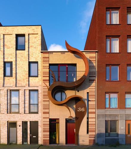 a building with a sculpture on the side of it at Huis met de krul in Amsterdam