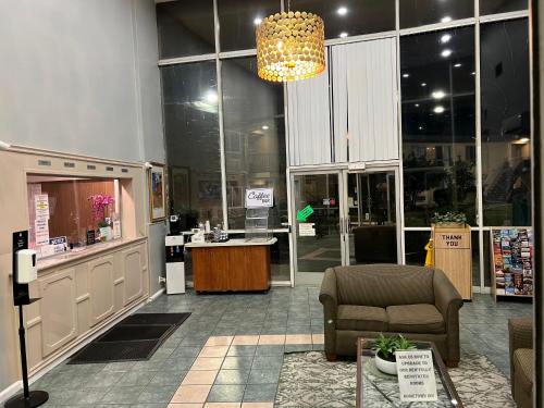 a store with a lobby with a chair and a counter at Hometown Inn North Hills in North Hills