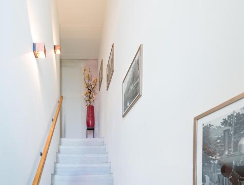 uma escada numa casa com um vaso na parede em Huis met de krul em Amsterdã