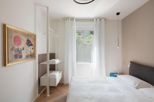 a white bedroom with a bed and a window at LaPalma Venezia (perfetto per famiglie) in Mestre