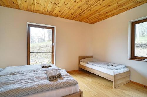 Posteľ alebo postele v izbe v ubytovaní Rekreačné domy pod Lipami
