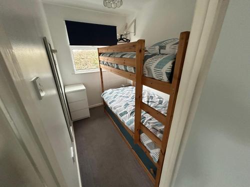 a small room with two bunk beds in it at 1st Floor family apartment Hillview in Brean