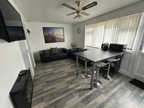 a living room with a table and a couch at 1st Floor family apartment Hillview in Brean