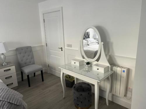 a bedroom with a dressing table and a mirror at Johnsville House in Carlow