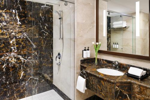 a bathroom with a sink and a shower at InterContinental Dar Al Hijra Madinah, an IHG Hotel in Al Madinah