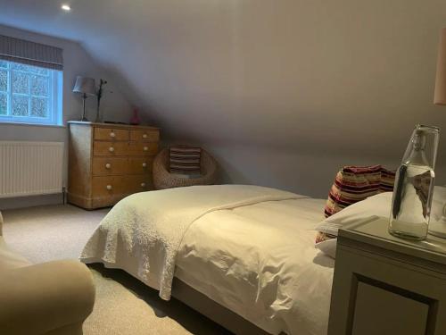 ein Schlafzimmer mit einem Bett, einer Kommode und einem Fenster in der Unterkunft Pass the Keys The Top Space in Hastings