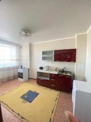 a room with a kitchen with a sink and a counter at Квартира in Kokshetau