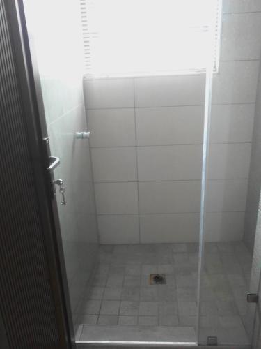 a shower with a glass door in a bathroom at Studio house in Durban
