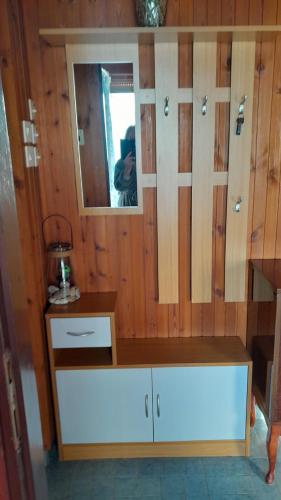 a cabinet with a mirror in a room at Apartment Ana in Opatija