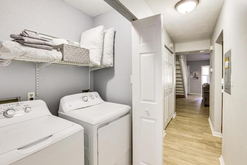 a white laundry room with a washer and dryer at Updated Tallahassee Townhome 3 Mi to Downtown! in Tallahassee
