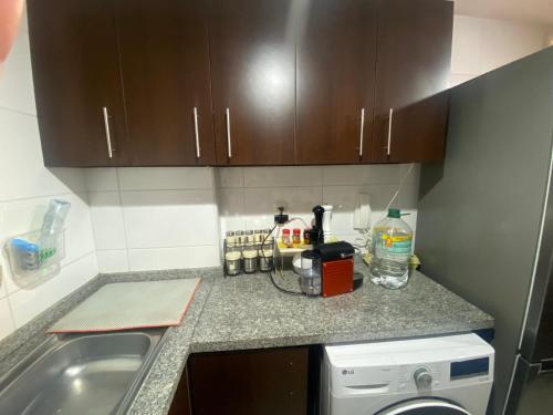a kitchen with a sink and a counter top at Costazul Playa la herradura in Coquimbo