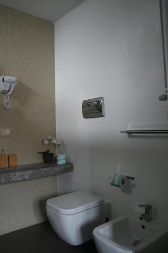 a bathroom with a white toilet and a sink at Bamboo Luxury B&B in Agrigento