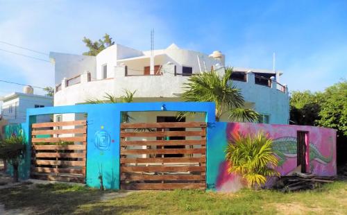 a blue house with a fence in front of it at Casa Redonda Hostal Inn 1 in Holbox Island