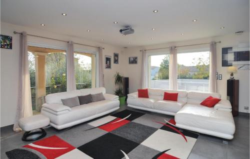 a living room with two white couches and a rug at Nice Home In Saint-Gilles in Saint-Gilles