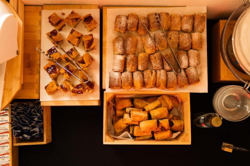 two boxes filled with different types of food at Adonis Hotel Studios & Apartments in Naousa