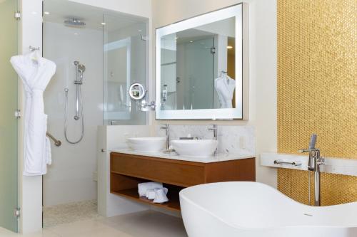 a bathroom with two sinks and a shower at Villa La Valencia Beach Resort & Spa Los Cabos in San José del Cabo