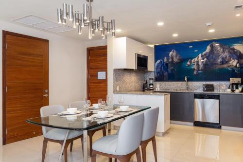 a dining room and kitchen with a table and chairs at Villa La Valencia Beach Resort & Spa Los Cabos in San José del Cabo