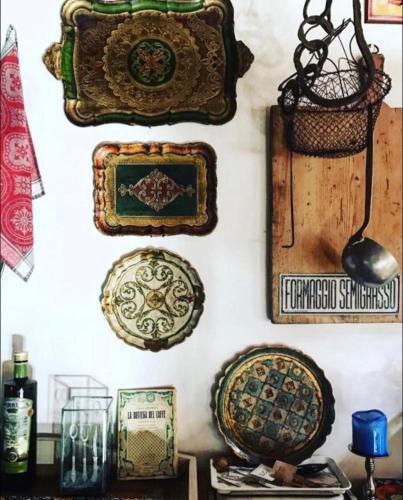 a wall with plates and other items on it at Locanda San Tomaso in Treviso