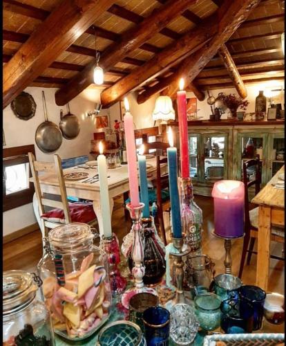a table with candles in vases on it in a kitchen at Locanda San Tomaso in Treviso