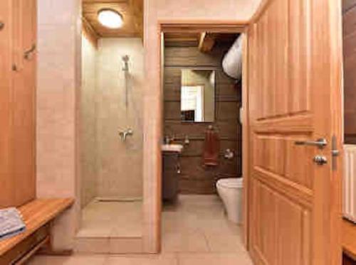 a bathroom with a shower and a toilet in it at FOREST RIVER RESORT in Vilnius