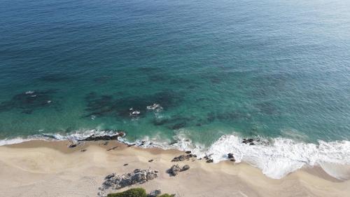 an overhead view of the ocean and the beach at OCEAN OASIS HOTEL - adult only, four casitas boutique resort in Playa Agua Blanca