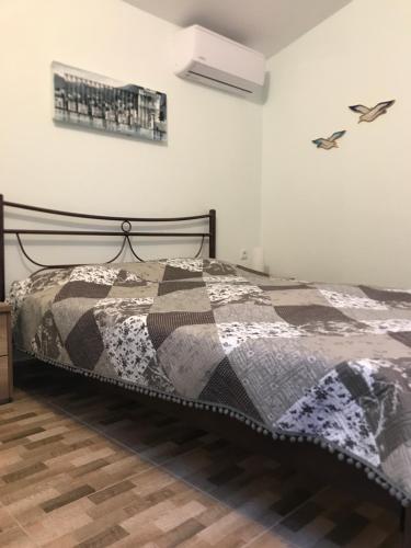 a bedroom with a bed with a quilt on it at Adorable 1 bedroom Vacation house near Sea. in Skala Fourkas