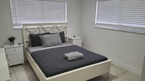 a bedroom with a bed with a pillow on it at Arpe 4plex in Fort Lauderdale