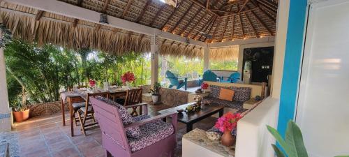 a living room with a table and chairs at OCEAN OASIS HOTEL - adult only, four casitas boutique resort in Playa Agua Blanca