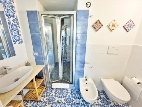 a bathroom with a shower and a toilet and a sink at Alfieri Rooms - Amalfi coast in Atrani
